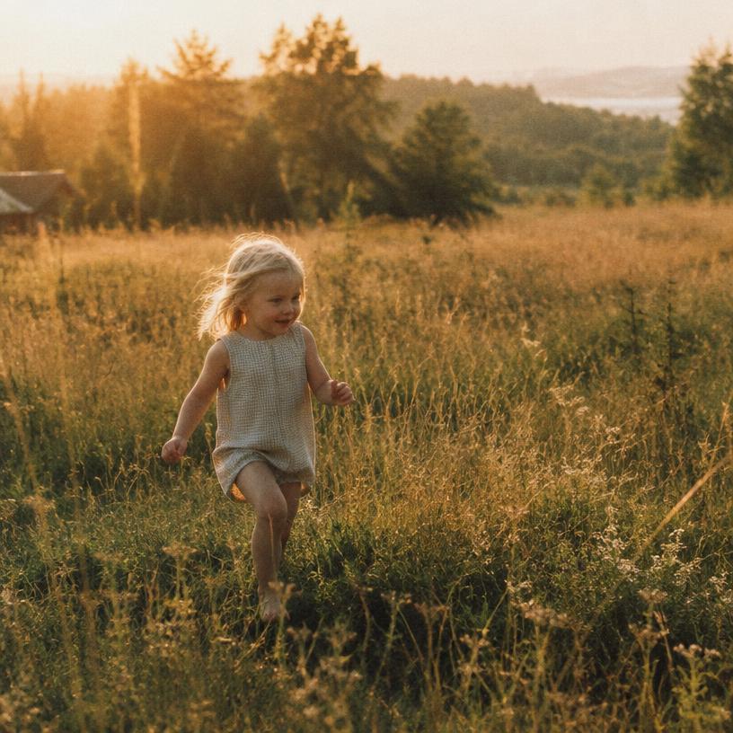 A child running through a summer field in golden light