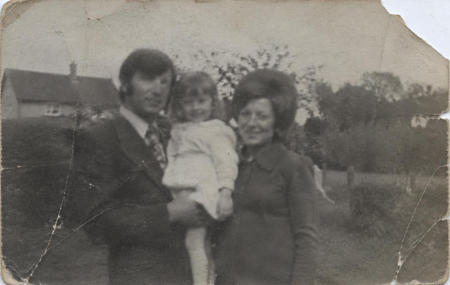 The same photograph before restoration: faded, scratched and torn