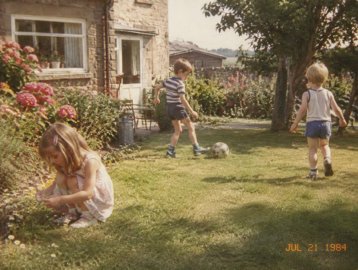 Children playing in a garden at their grandmother's house, summer 1984